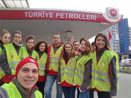 Turkish Petroleum and Turkuaz Petrol employees stand shoulder to shoulder with dealers and customers in stations.